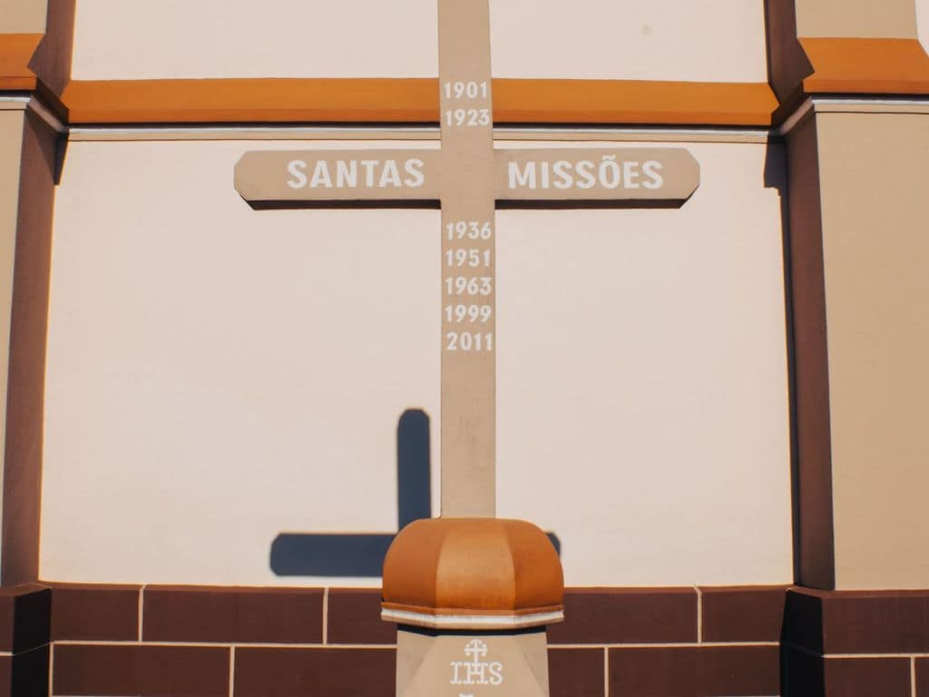 Holy Missions cross in front of a church